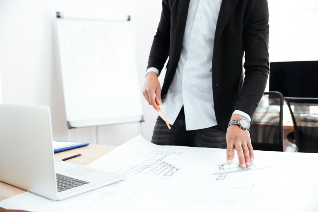 Cropped image of a businessman standing at desk with documents